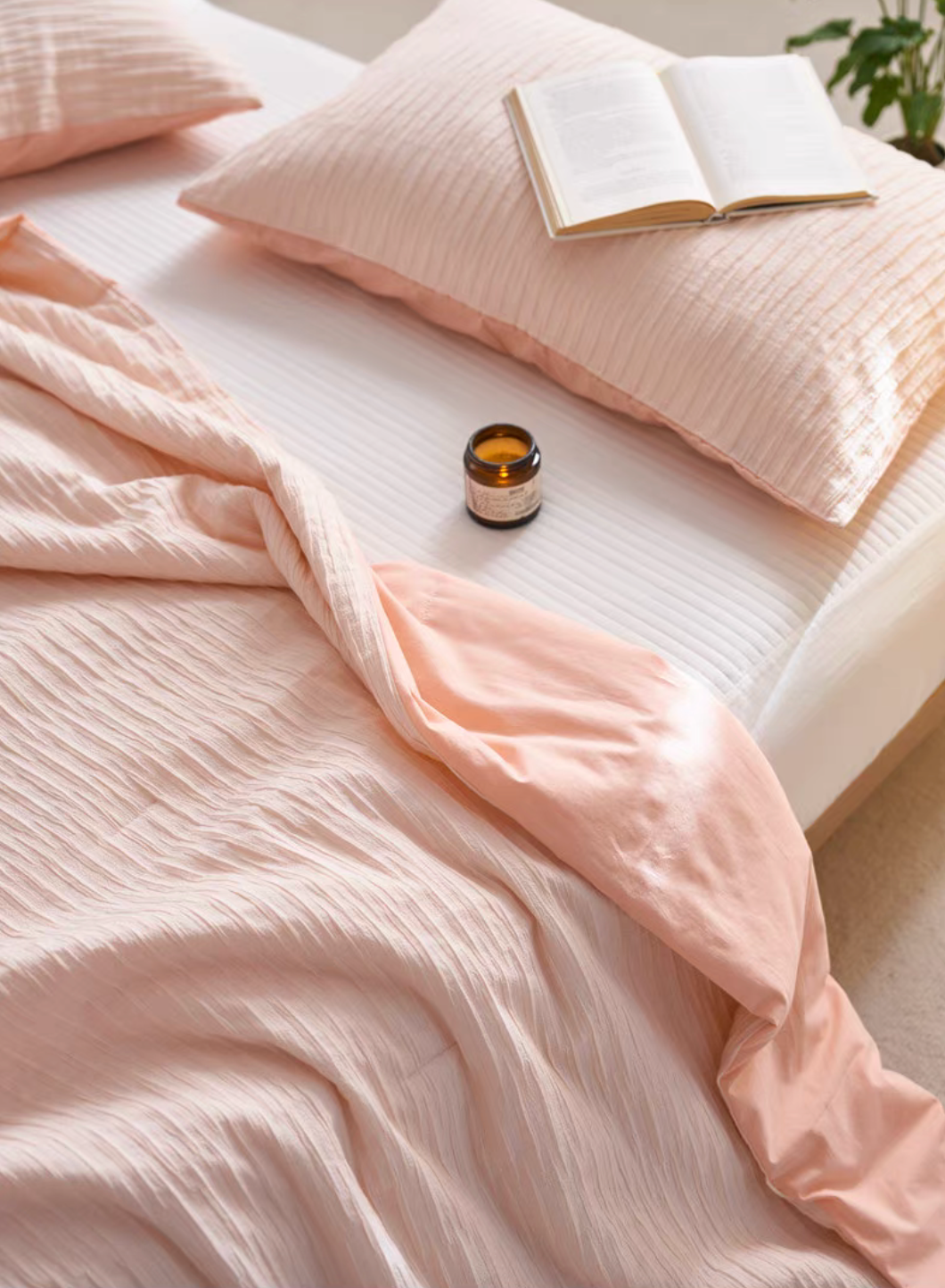 Pink Colorful cotton comforter and sham set close-up with pillow sham, candle, and soft jacquard wave texture