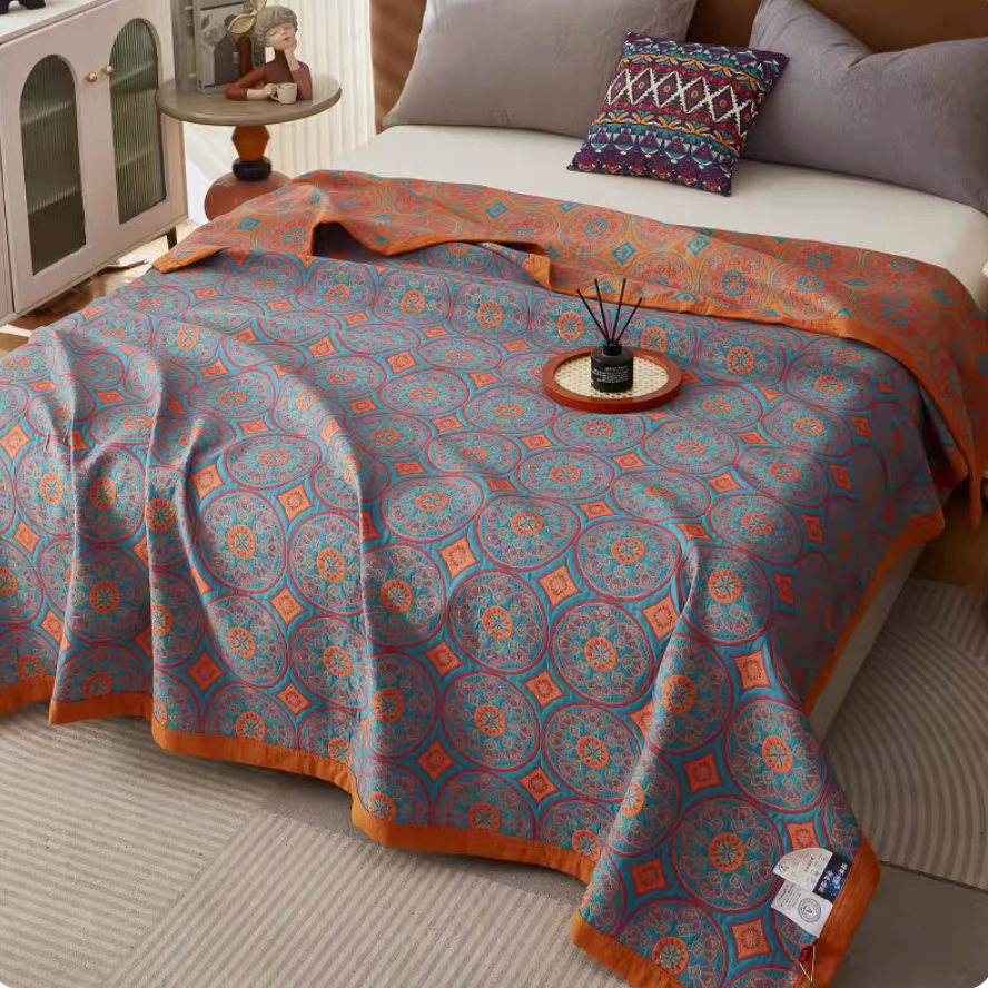 Angled view of Colorful Harmony Cotton Woven Quilt Bolivia Blue showing vibrant circular pattern on cotton quilt