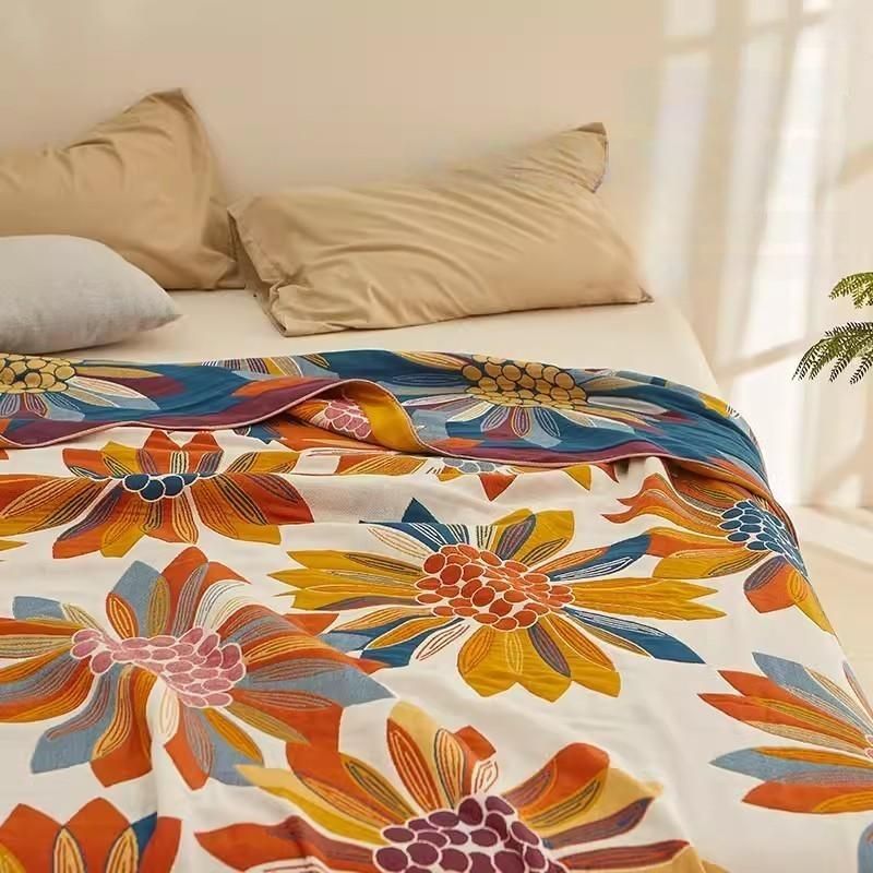 Colorful Super Soft Long-staple Cotton Blanket Sunflower styled across a bright bedroom bed with floral pattern