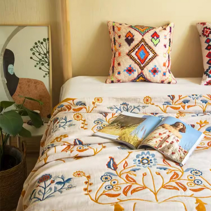 Colorful Super Soft Long-staple Cotton Blanket Time Blossom styled on a bedroom bed with decorative pillows and floral bedding