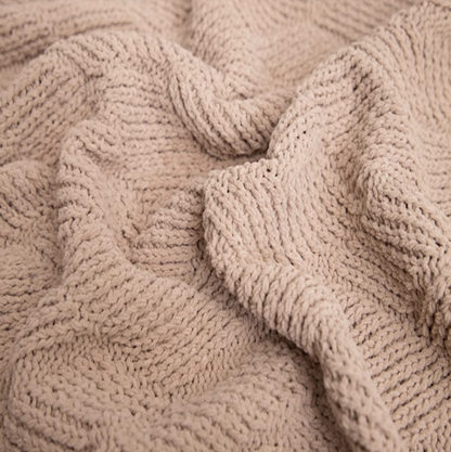 Close-up of almond chenille cable knit throw blanket showing plush texture and detailed woven cable pattern
