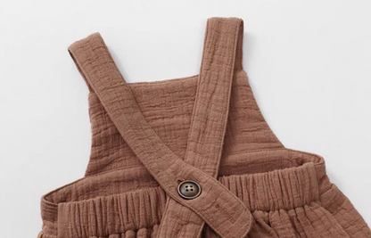 Dusty rose cotton gauze baby romper cross back strap with button detail soft breathable fabric