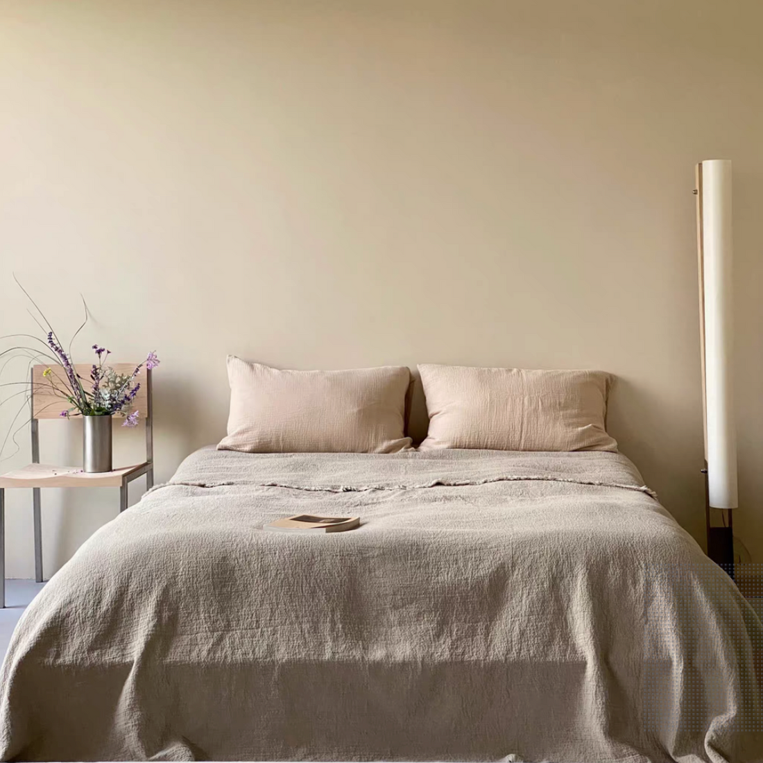 French flax linen duvet thin quilt in natural classic linen color styled on minimalist bedroom bed with raw edge texture and stonewashed linen fabric