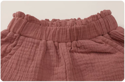 Hot pink gauze cotton baby shorts elastic waistband detail soft breathable fabric close up