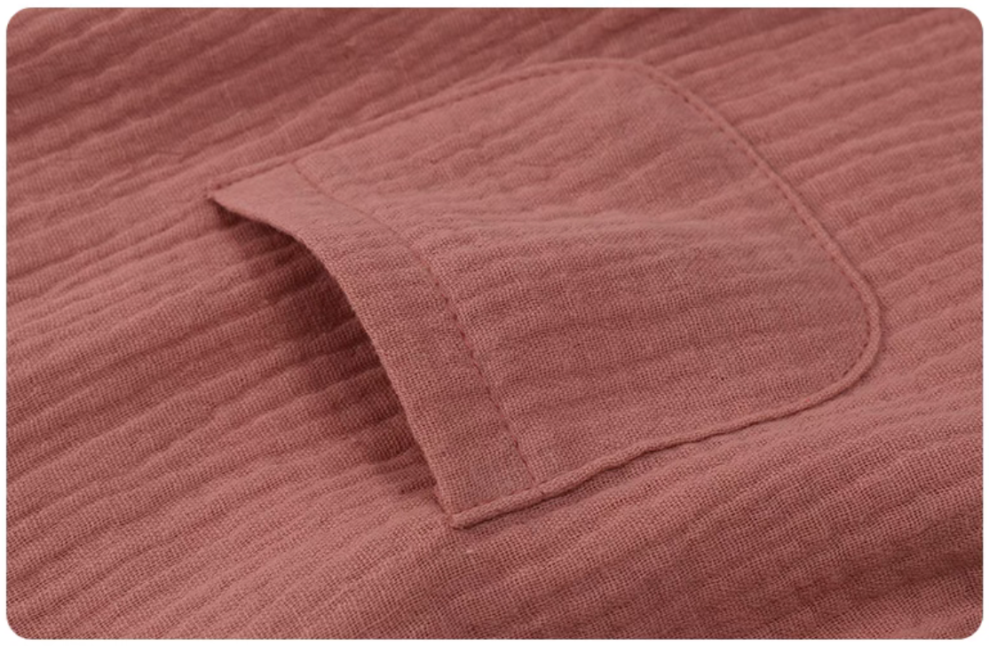 Hot pink gauze cotton baby set pocket detail soft breathable textured fabric close up