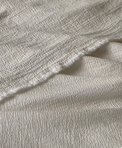 Minimalist bedroom styled with ivory white French flax linen duvet thin quilt featuring lightweight breathable linen bedding