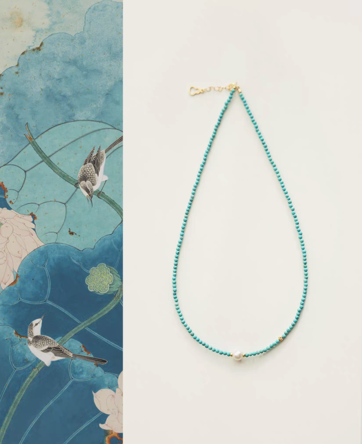 Micro turquoise bead choker with single freshwater pearl and gold clasp full product view on clean background