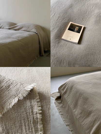Detailed close up of natural French flax linen duvet thin quilt fabric texture highlighting breathable crinkled linen weave