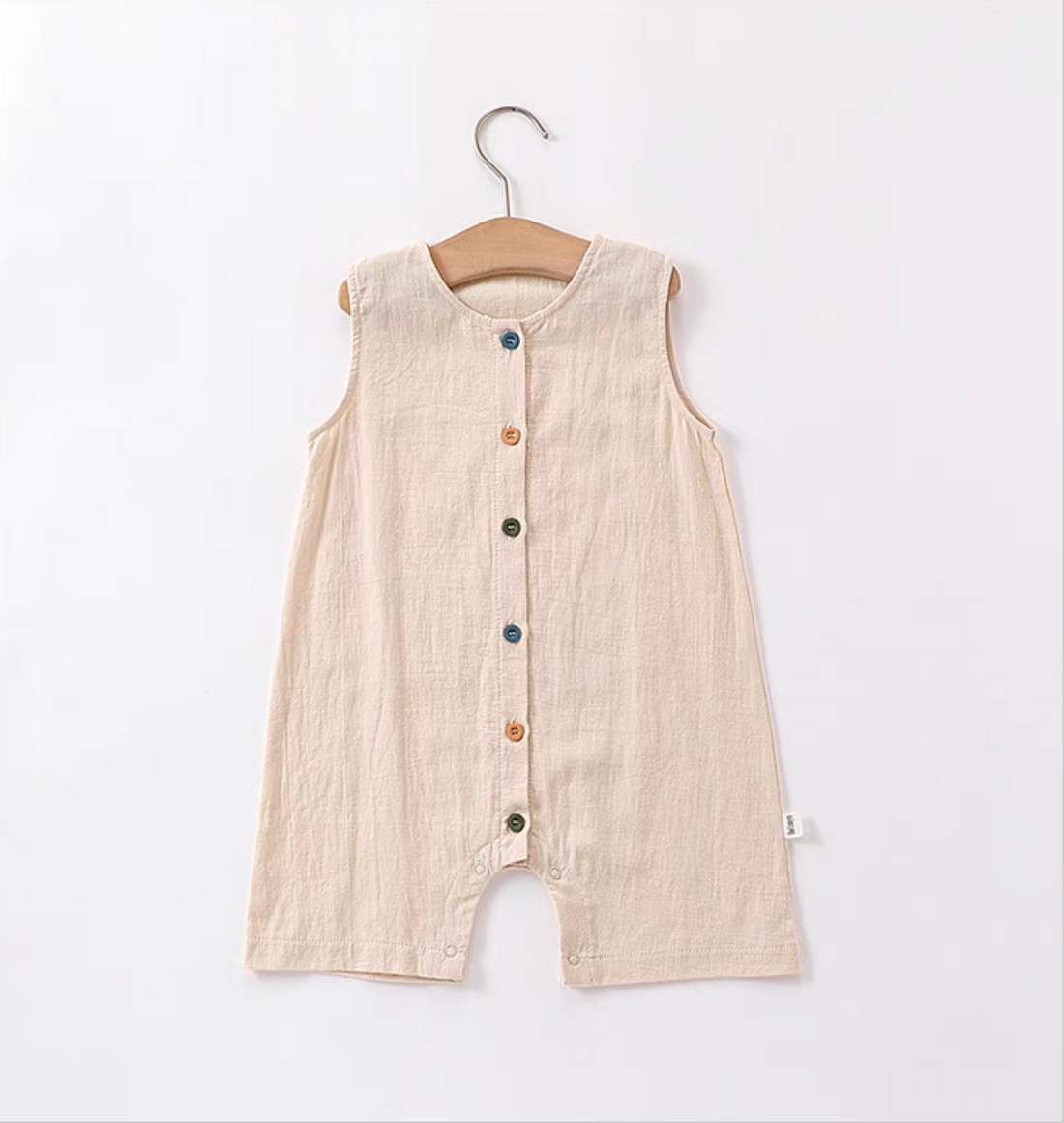 Peach sleeveless cotton baby romper with colorful button front soft breathable lightweight summer outfit front view