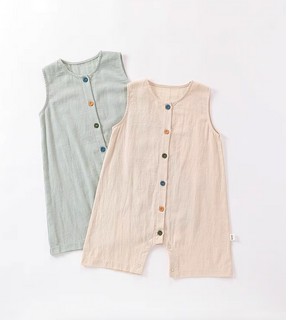 Sage green and peach sleeveless cotton baby rompers with colorful button front soft breathable summer outfit flat lay
