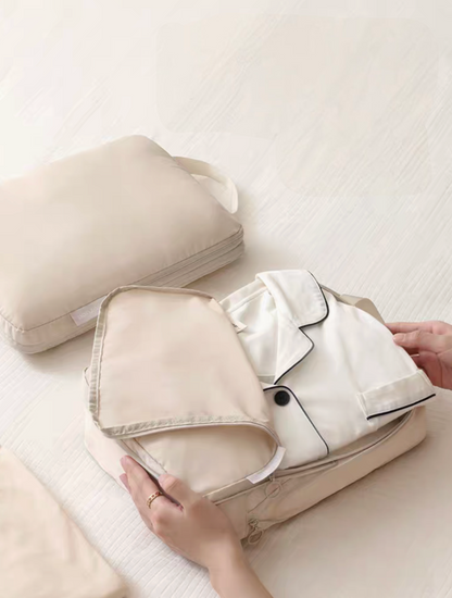 Beige Compression Travel Packing Cubes with Shoe and Clothing Organizer Set with opened clothing cube holding folded pajama set