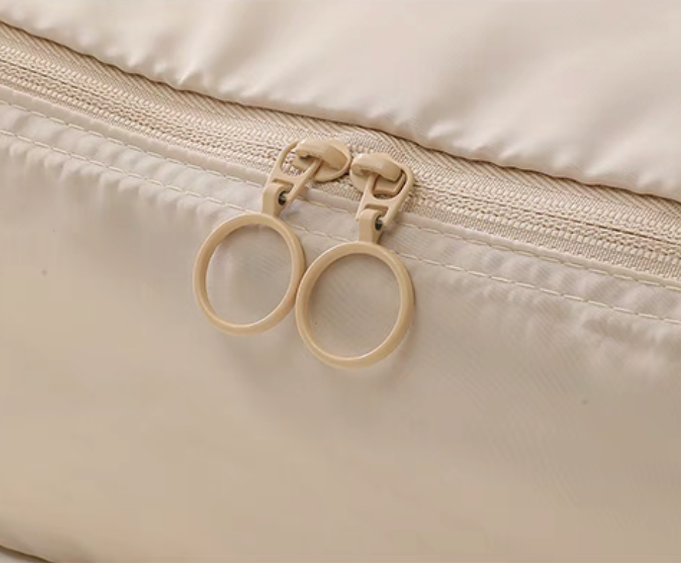 Close-up of Beige Compression Travel Packing Cubes with Shoe and Clothing Organizer Set showing dual zipper pull detail on the packing cube