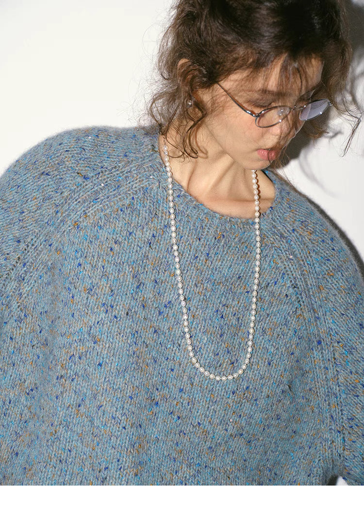 Close-up of crystal blue confetti knit sweater showing soft speckled yarn and crewneck detail
