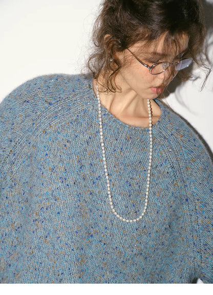 Close-up of crystal blue confetti knit sweater showing soft speckled yarn and crewneck detail
