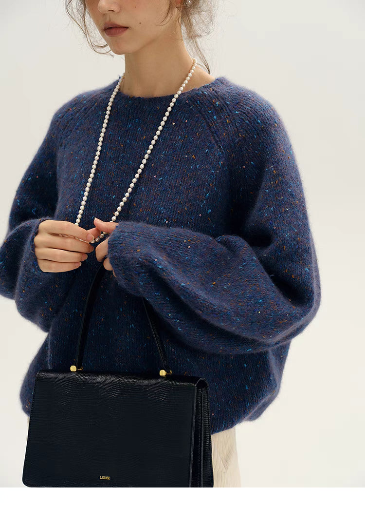 Fantasy purple confetti knit sweater styled with handbag focusing on sleeve volume and knit texture