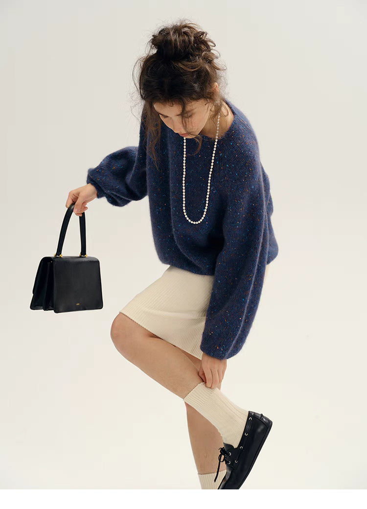 Fantasy purple confetti knit sweater styled with skirt and boots showing relaxed oversized fit and modern outfit pairing