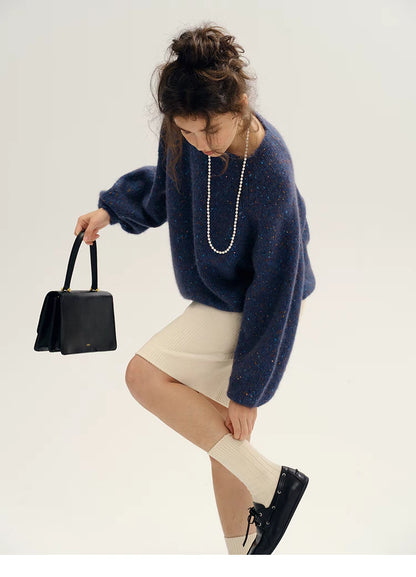 Fantasy purple confetti knit sweater styled with skirt and boots showing relaxed oversized fit and modern outfit pairing