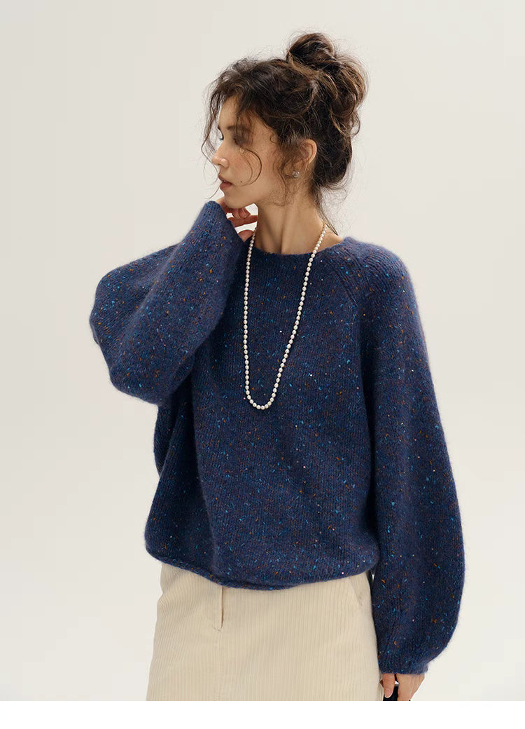 Fantasy purple confetti knit sweater shown in side profile emphasizing dropped shoulders and loose silhouette