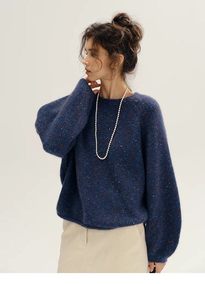 Fantasy purple confetti knit sweater shown in side profile emphasizing dropped shoulders and loose silhouette