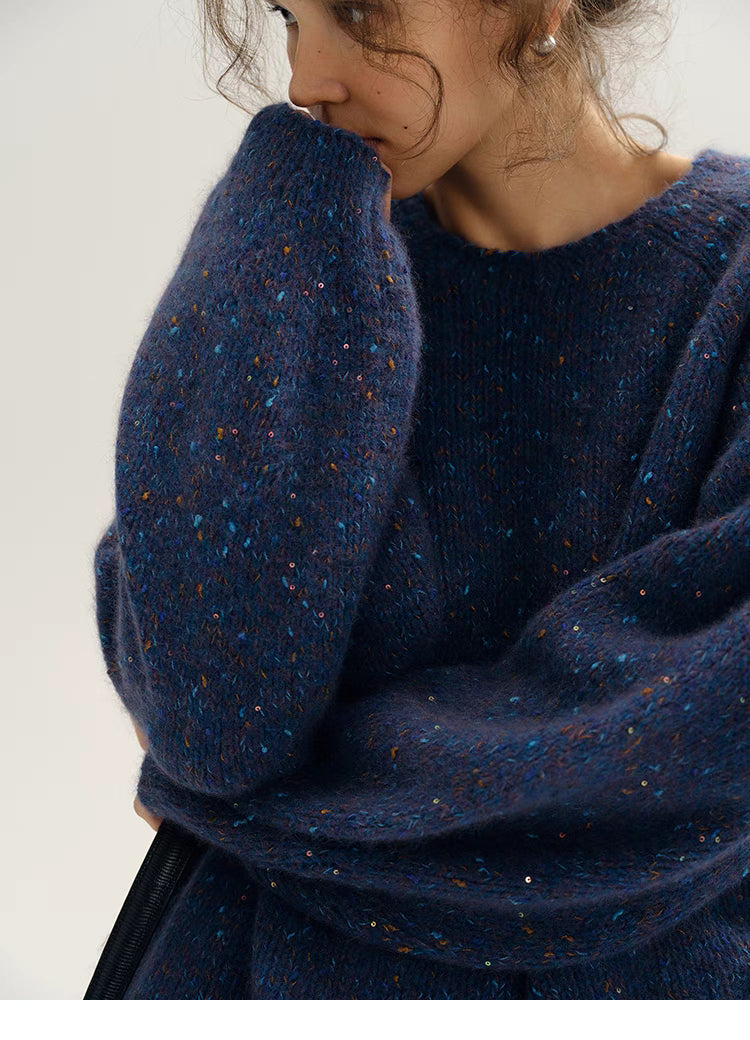 Close-up of fantasy purple confetti knit sweater sleeve showcasing plush texture and multicolor flecks