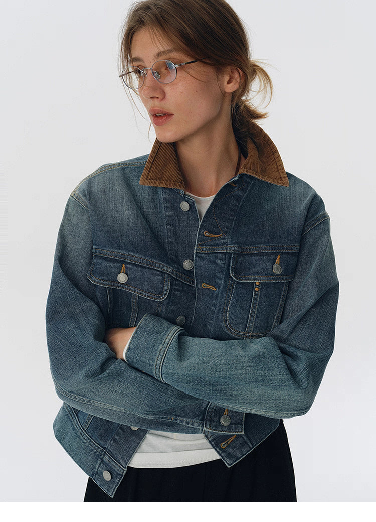 Model wearing washed blue denim jacket with contrast corduroy collar, arms crossed