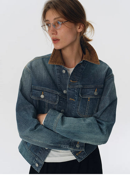 Model wearing washed blue denim jacket with contrast corduroy collar, arms crossed