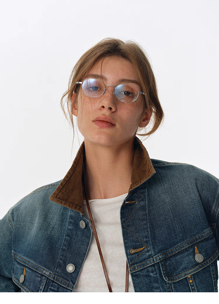Close-up of brown corduroy collar and upper chest on washed blue denim jacket