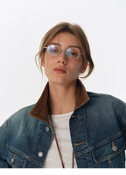 Close-up of brown corduroy collar and upper chest on washed blue denim jacket
