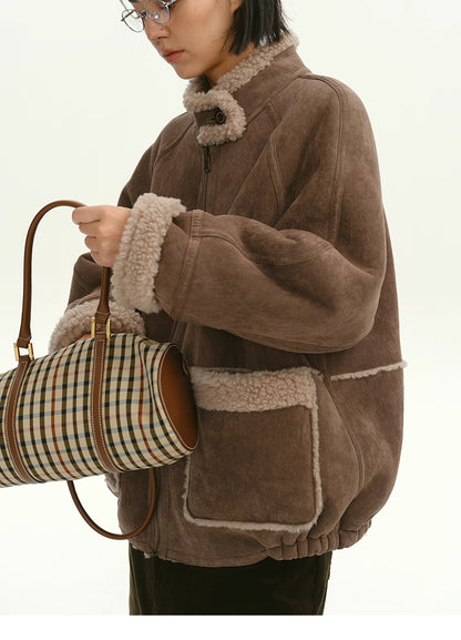 Cocoa brown shearling-trim suede jacket front view with model carrying plaid bag
