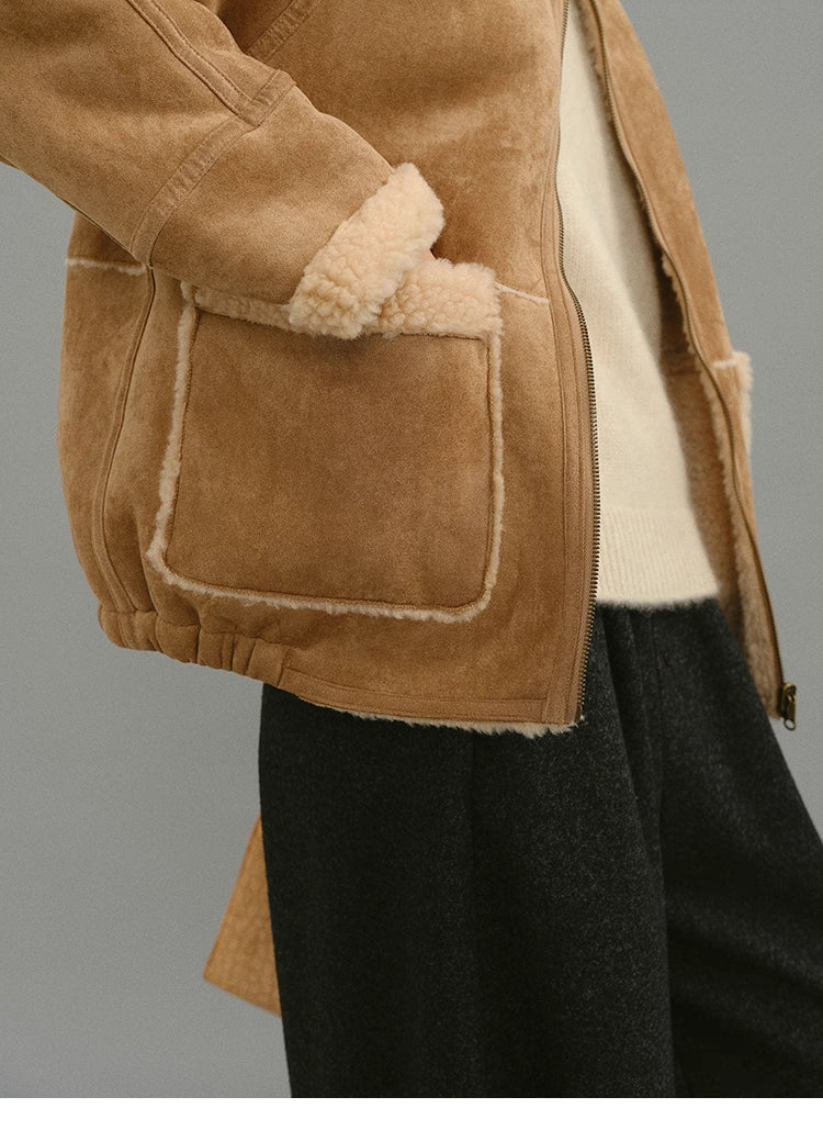 Close-up of light camel jacket pocket with contrast shearling trim