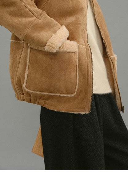 Close-up of light camel jacket pocket with contrast shearling trim