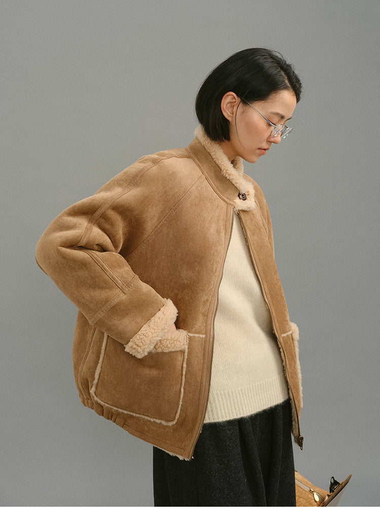 Light camel shearling jacket side profile showing raglan sleeve and trim details