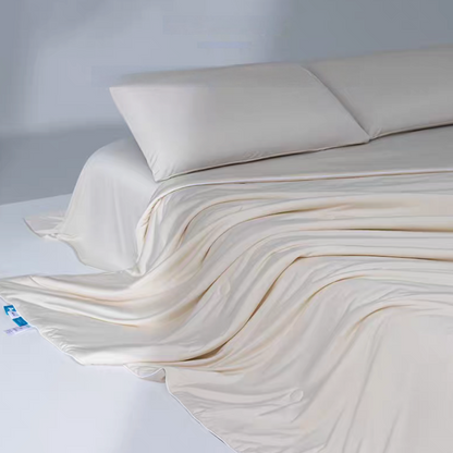 Beige cooling antibacterial summer quilt flowing across a bed showing lightweight breathable cooling comforter design.