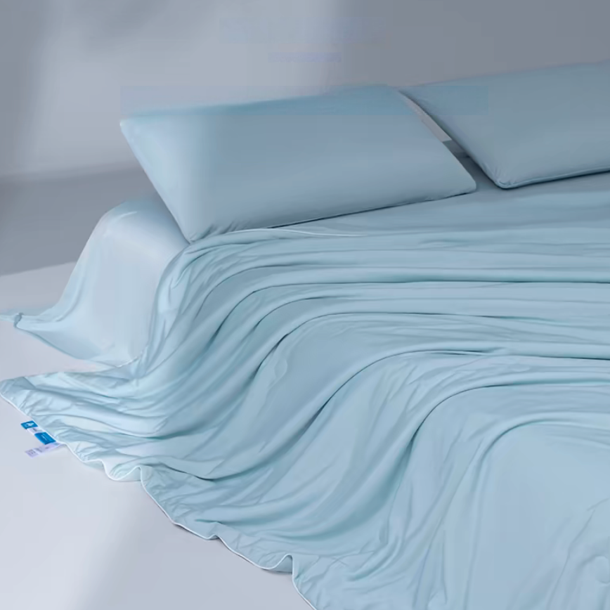 Light blue cooling summer quilt draped across a bed demonstrating smooth Evercool cooling fabric and breathable comfort.