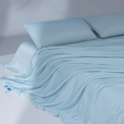 Light blue cooling summer quilt draped across a bed demonstrating smooth Evercool cooling fabric and breathable comfort.