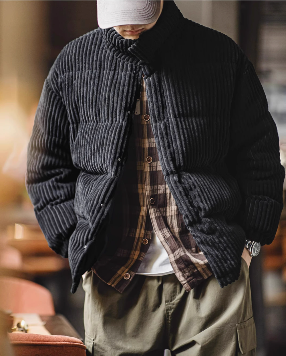 Front open view of Black corduroy down jacket styled with inner layers showing versatility and relaxed fit