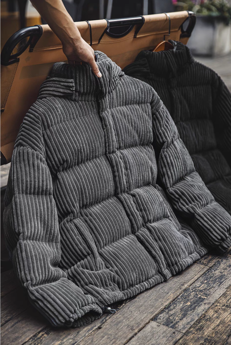 Dark Gray corduroy down jacket hanging on rack highlighting thick quilted texture and structured collar design