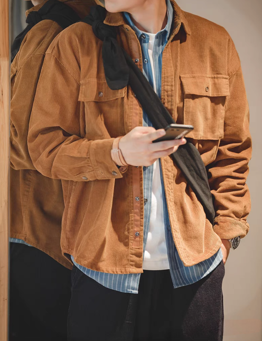 Man wearing Amber Corduroy Field Shirt layered over striped shirt showing relaxed fit and vintage workwear style
