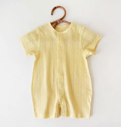 Light yellow cotton baby romper hanging front view soft summer color with breathable fabric