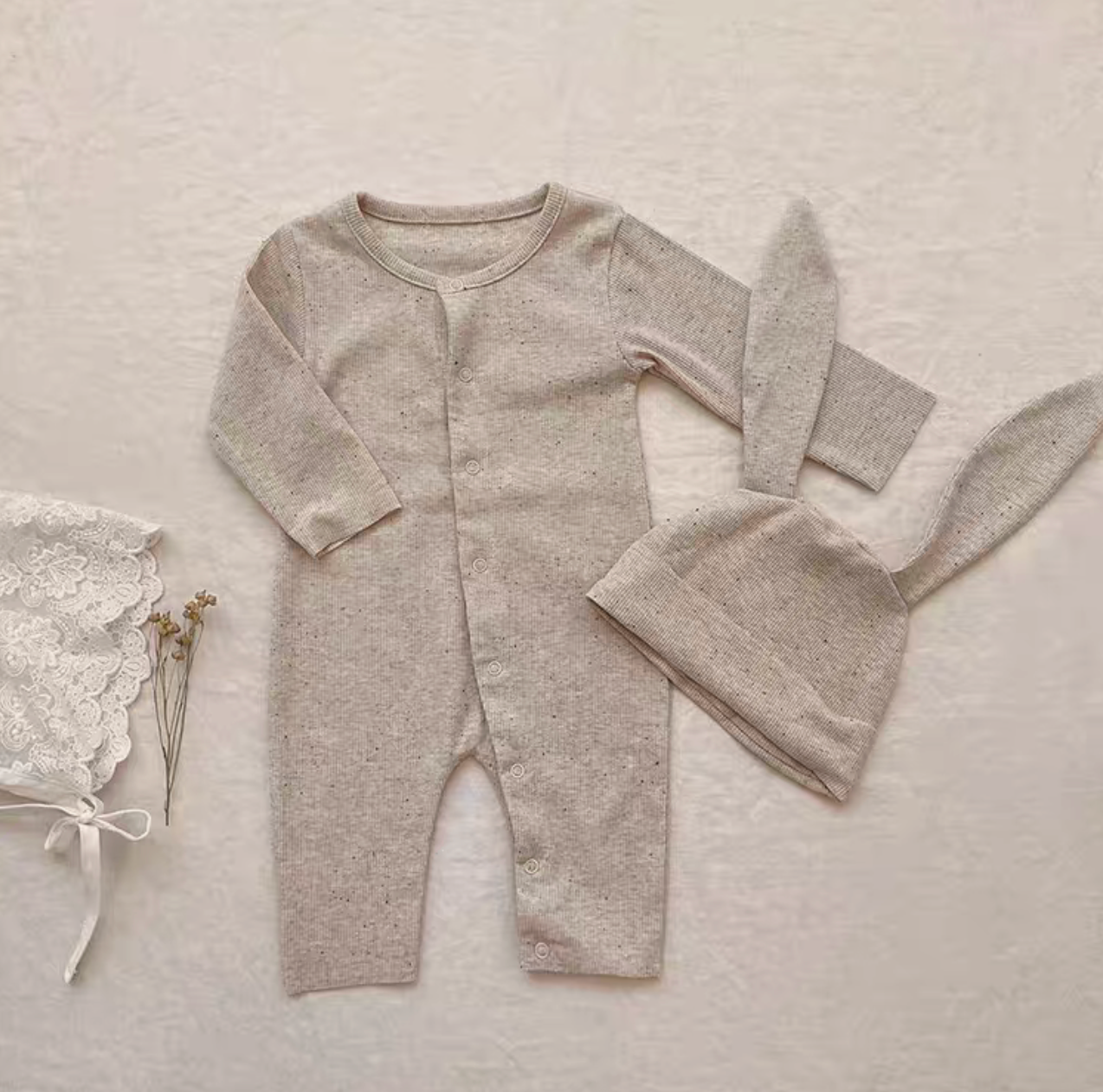 Flat lay oatmeal beige long baby romper with bunny ear hat soft cotton outfit set