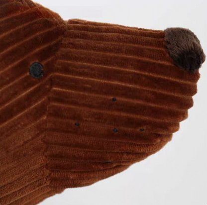 Close-up of brown dachshund pillow face showing soft corduroy texture and stitched details