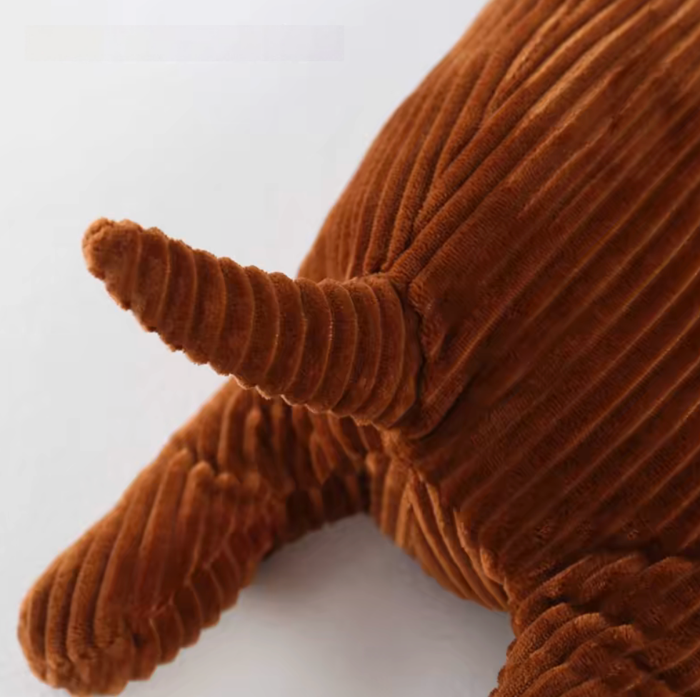 Close-up of brown dachshund pillow tail and back texture with ribbed plush fabric