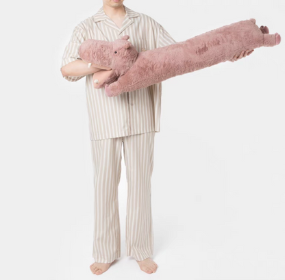 Pink hippo long body pillow held horizontally showing full plush body and soft texture
