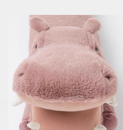 Close-up front view of pink hippo long body pillow showing soft plush face and rounded snout details