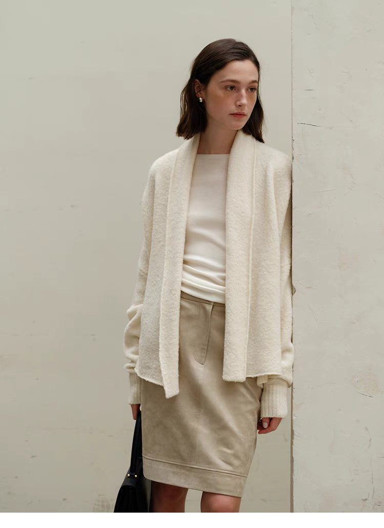 Full-body styling of Cozy Elegance Oversized Knit Cardigan in Ivory paired with skirt showing relaxed fit, ribbed cuffs, and elegant layering look
