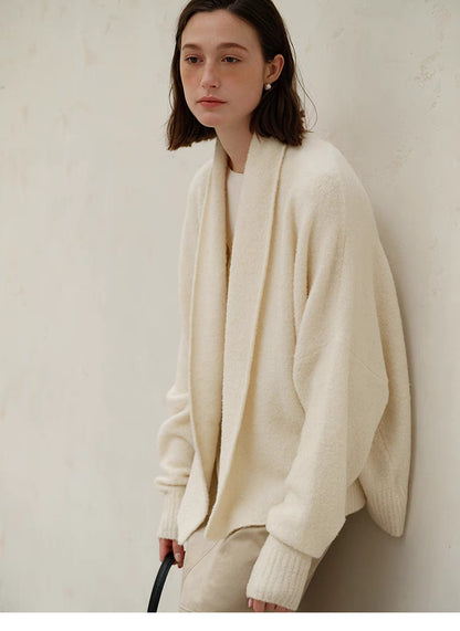 Side view of Cozy Elegance Oversized Knit Cardigan in Ivory highlighting soft draped shawl collar, oversized fit, and cozy knit texture