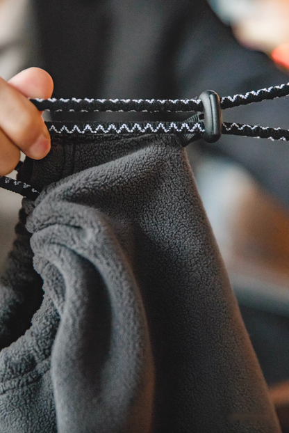 Close-up of Cozy Magic Neck-Warmer in gray featuring adjustable toggle cord system for secure and customizable fit