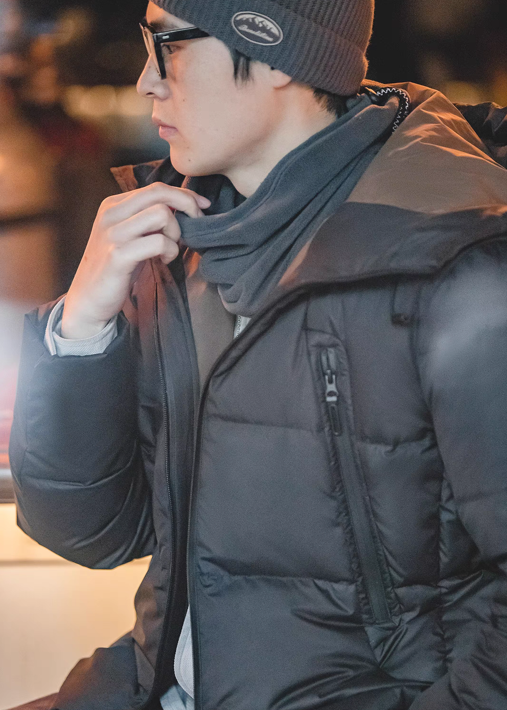 Side profile of Cozy Magic Neck-Warmer in gray worn with winter jacket highlighting minimalist design and comfortable fit