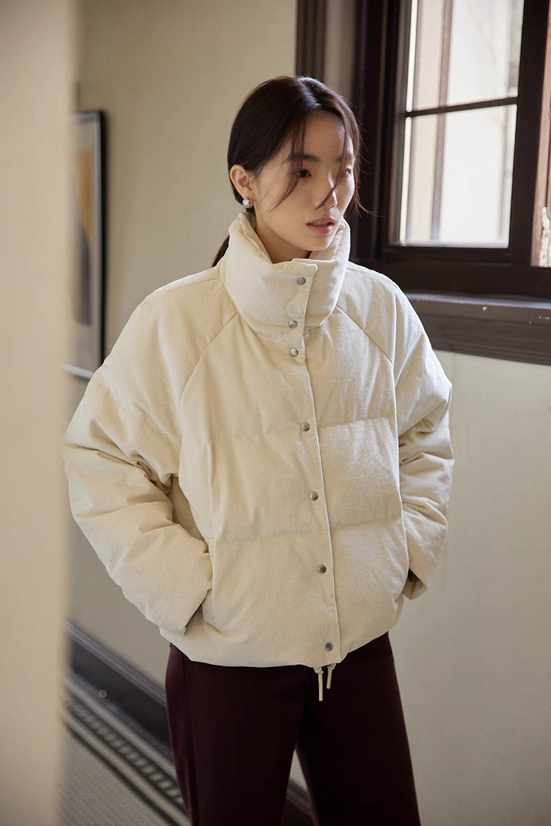 Front view of Cozy Quilted Corduroy Coat in off white showcasing stand collar, snap button closure, and quilted corduroy texture