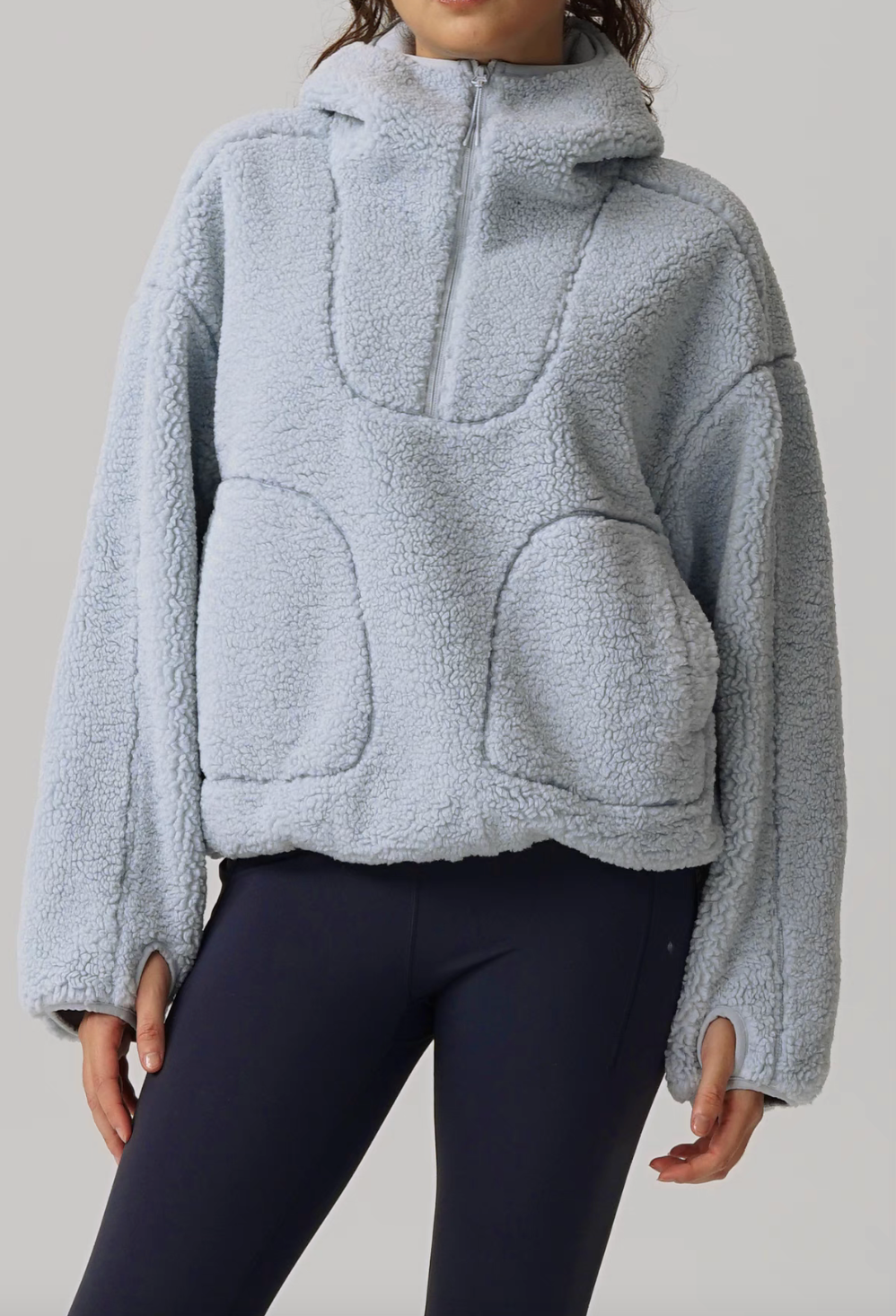 Front studio view of Cozy Sherpa Thermal Hoodie Pullover in light blue featuring half-zip closure, kangaroo pockets, and relaxed cropped fit